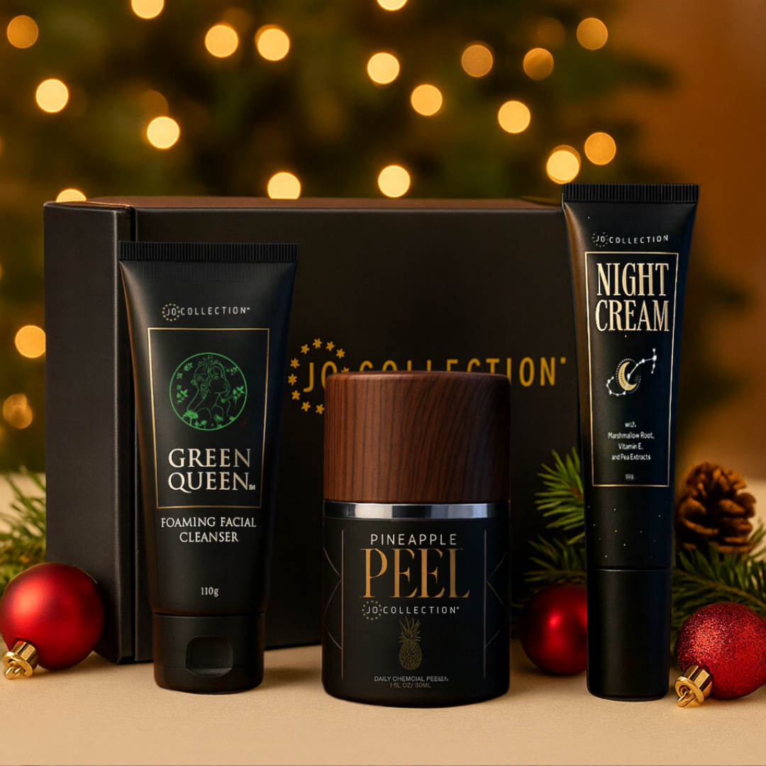 Cosmetic products from the Jo Collection with festive decorations and blurred lights in the background