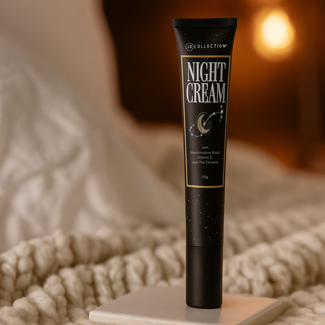 Jo Collection Night Cream with Marshmallow root vitamin e and pea extracts on bed in warmly lit scene