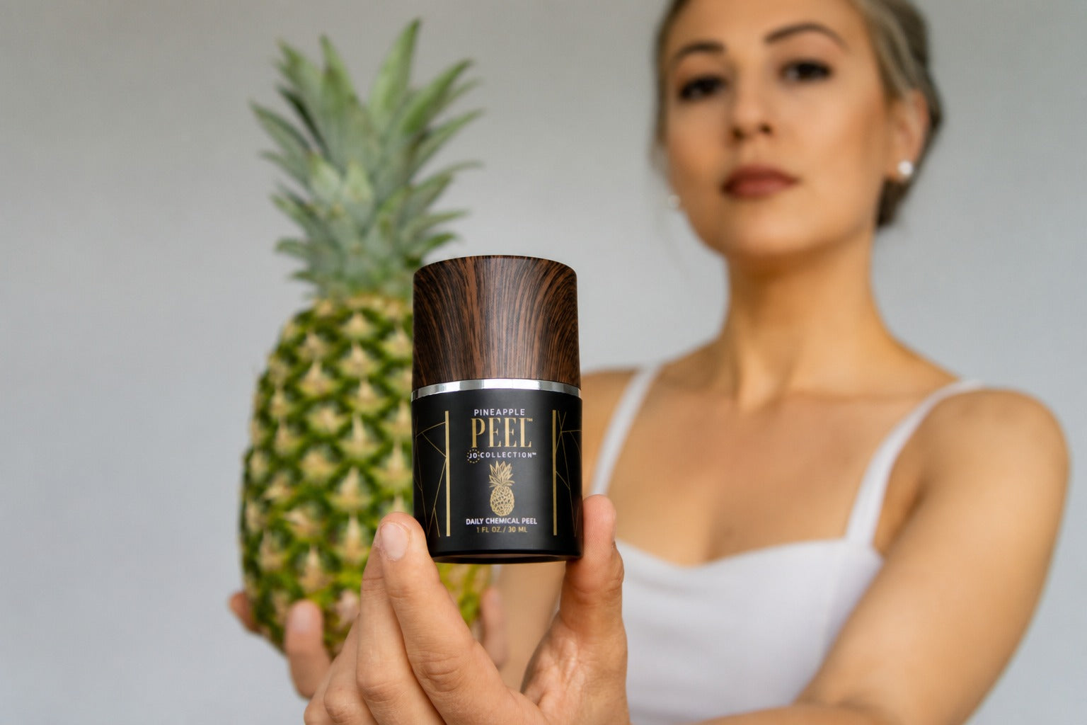 Woman holding Pineapple Peel skin care