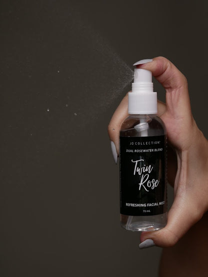 hands spraying Jo Collections Twin Rose rosewater facial mist