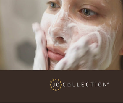 woman putting on and using a facial foaming cleanser